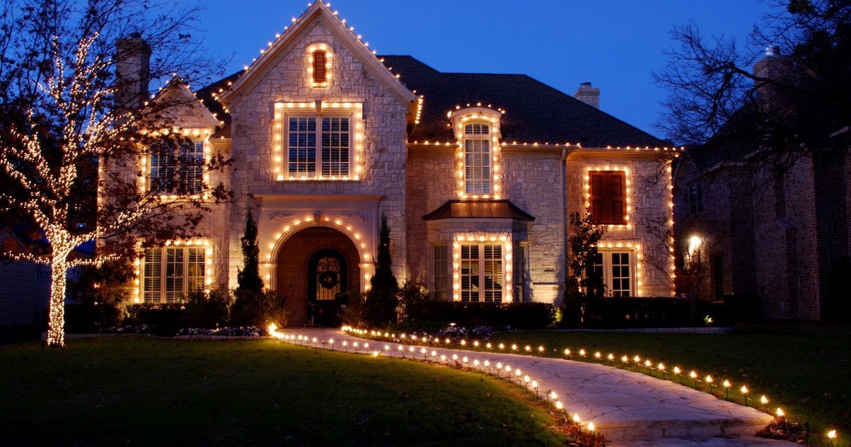 holiday lighting installed on house and walkway in front yard